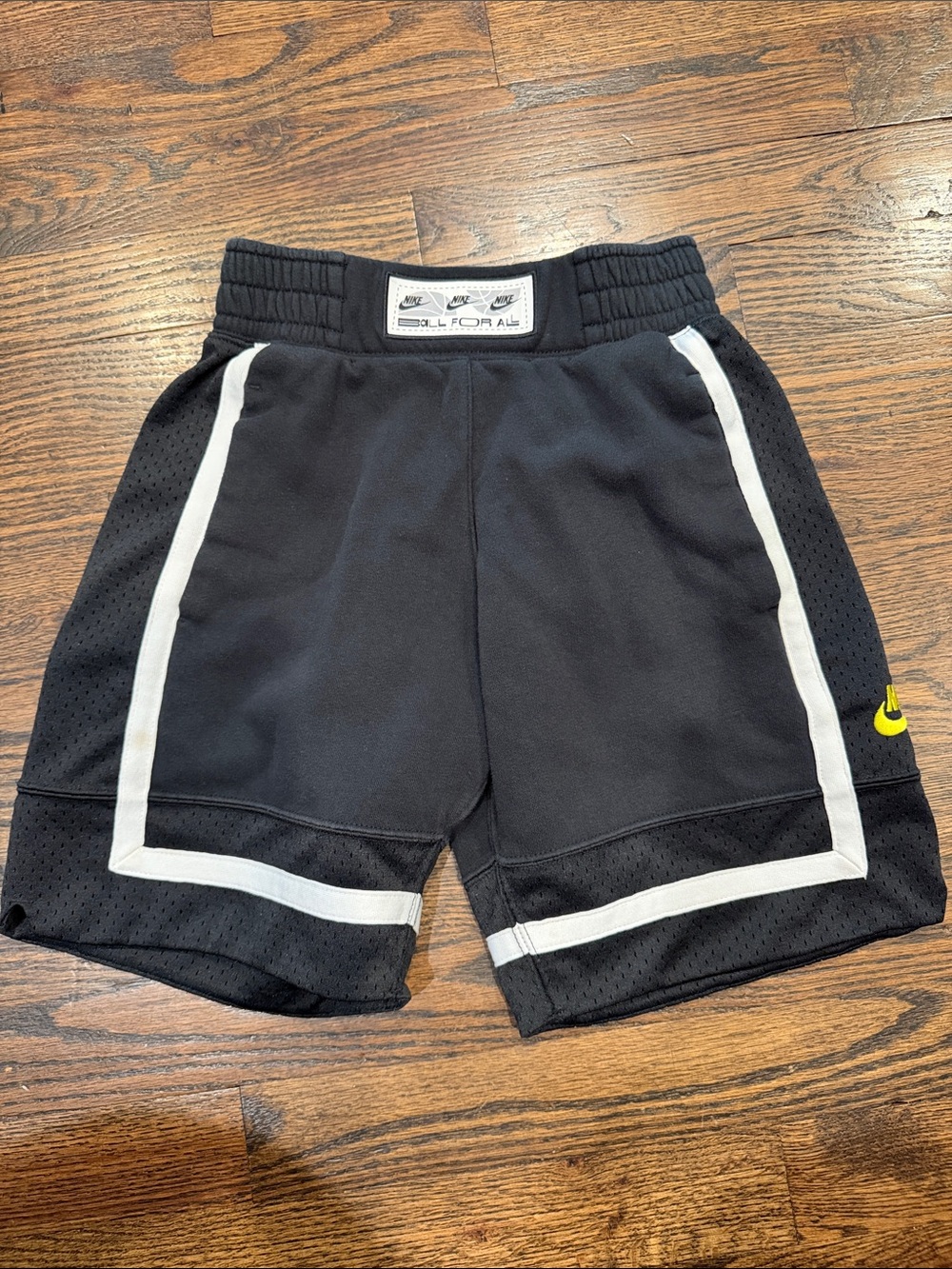 Nike Black Kids' Athletic Shorts with White Trim and Yellow Swoosh